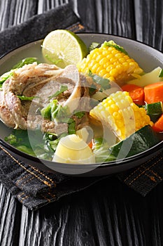 Caldo de resÃÂ is a traditional Mexican beef soup made with beef chunks and vegetables closeup in the plate. Vertical